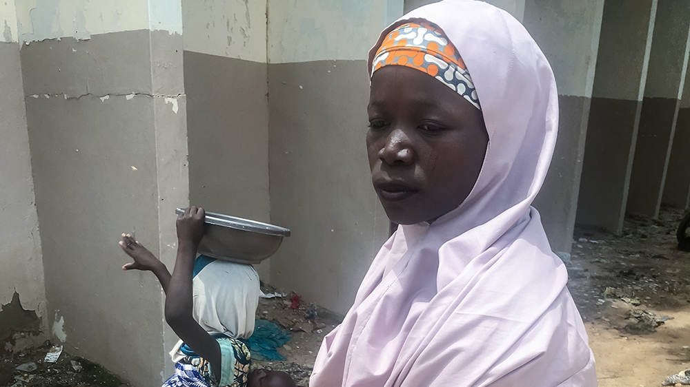 Zuleiya Sura, 22, and her children survivied a two-day trek in the bush to escape the attackers [Eromo Egbejule/Al Jazeera]