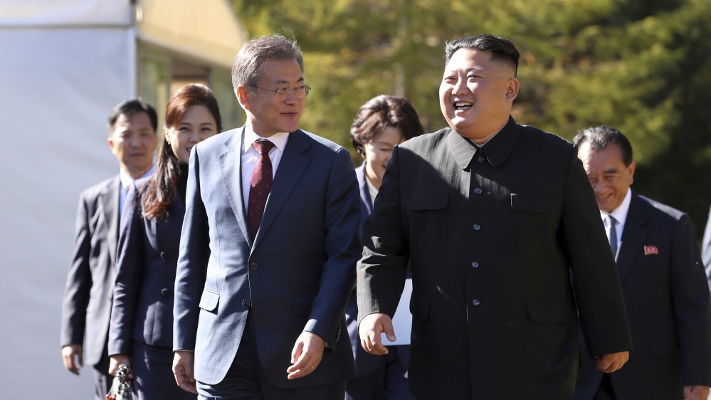 South Korean President Moon Jae-in, left, walks with North Korean leader Kim Jong Un