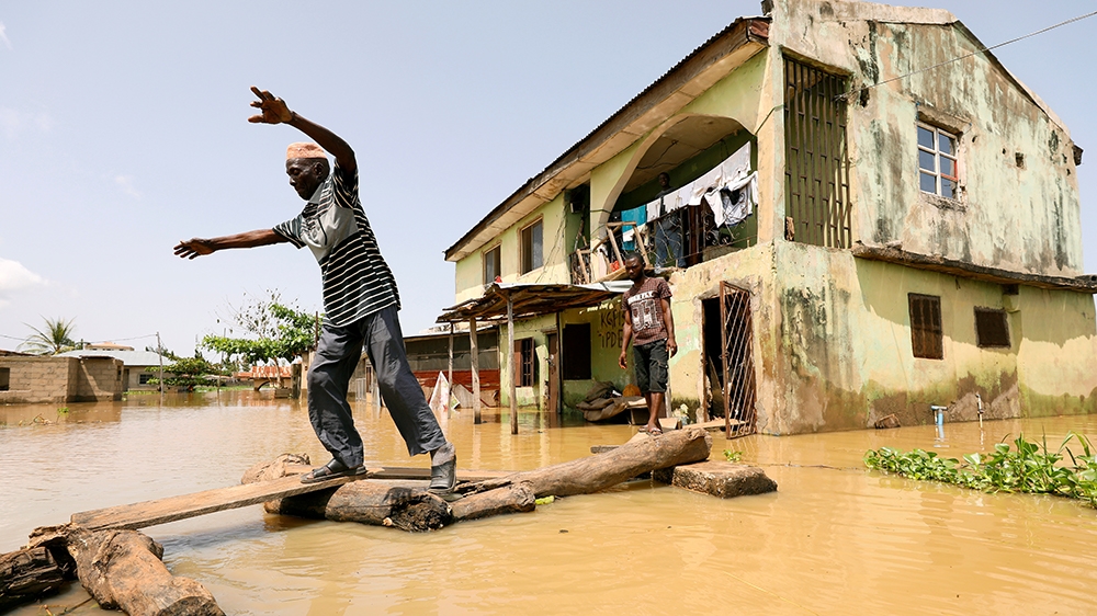 A man makes his way through flood waters in Kogi State, Nigeria September 17, 2018. REUTERS/Afolabi Sotunde