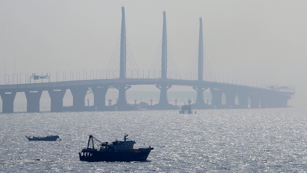 A boat sails near the Hong Kong-Zhuhai-Macau Bridge, in Zhuhai city, south China''s Guangdong province, Wednesday, March 28, 2018. The Hong Kong-Zhuhai-Macau Bridge, the world''s longest cross-sea proje