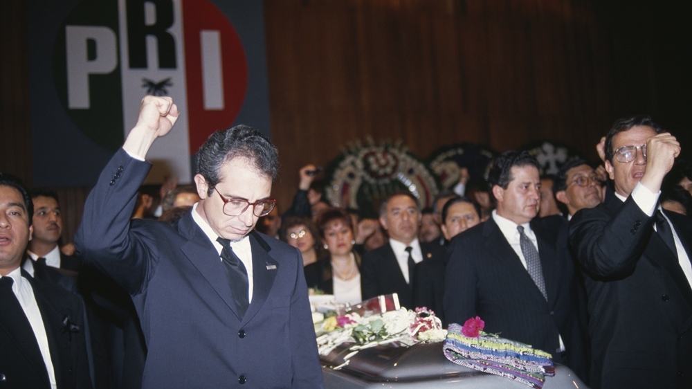 Mexican politician Ernesto Zedillo raises his fist in honour of presidential candidate Luis Donaldo Colosio, who was killed during the 1994 election campaign [File: Sergio Dorantes/Sygma via Getty Images] 