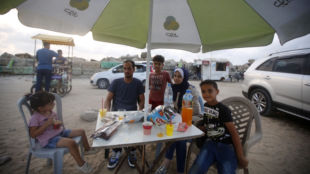 The Dilly family visit a spit of land near the Gaza harbour to escape their daily difficulties [Abdel Kareem Hana/Al Jazeera]