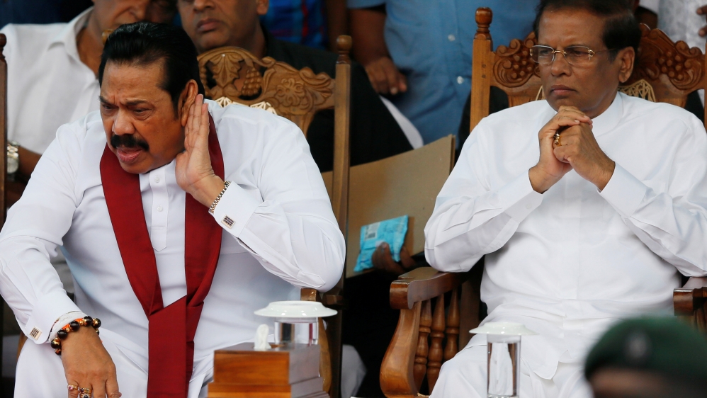 Sri Lanka''s newly appointed Prime Minister Rajapaksa reacts next to President Sirisena during a rally near the parliament in Colombo