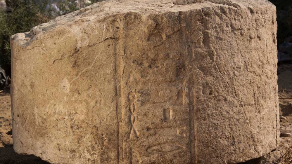 A photo released by the Egyptian Ministry of Antiquities shows part of a stone slab that was discovered at a dig in eastern Cairo [Egyptian Ministry of Antiquities via AP]