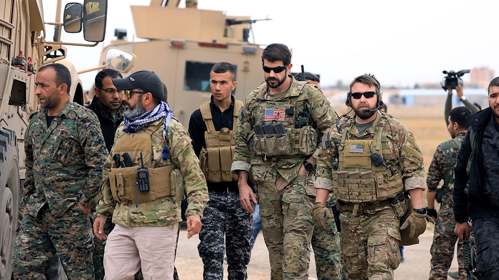 Syrian Democratic Forces and US troops are seen during a patrol near the Turkish border in Hasakah [File: Rodi Said/Reuters] 