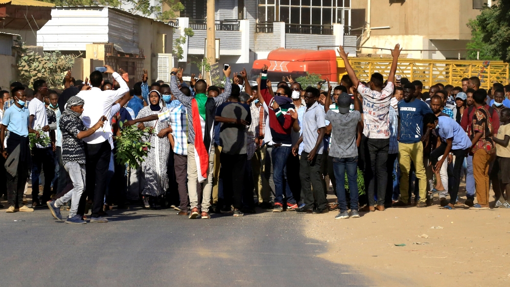 Sudanese demonstrators chant slogans as they march along the street during anti-government protests in Khartoum