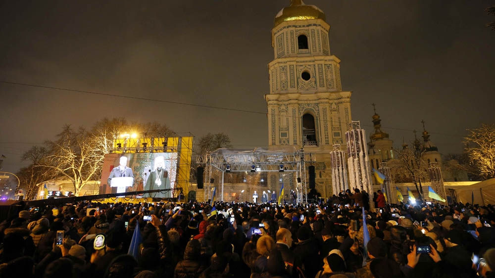 Ukrainian believers gather in front of Saint Sophia's Cathedral in Kiev [Gleb Garanich/Reuters]