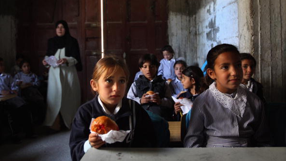 World Food Program Threatened by Rising Food Prices YATTA, WEST BANK - APRIL 21: Palestinian schoolgirls continue with their lessons eating vitamin-enriched snacks provided daily by the WFP