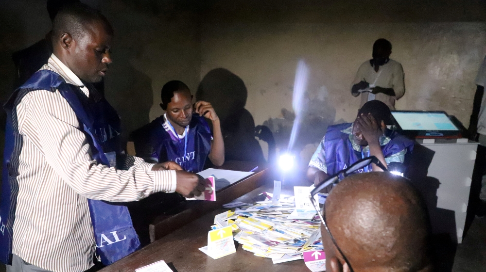 FILE PHOTO: Agents of Congo''s National Independent Electoral Commission (CENI) count casted ballot papers after election at a polling station in Kinshasa