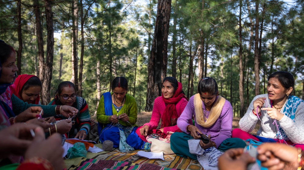 
Since forming five years ago, 14 women now meet regularly to for a knitting session [Maria de la Guardia/Al Jazeera]
