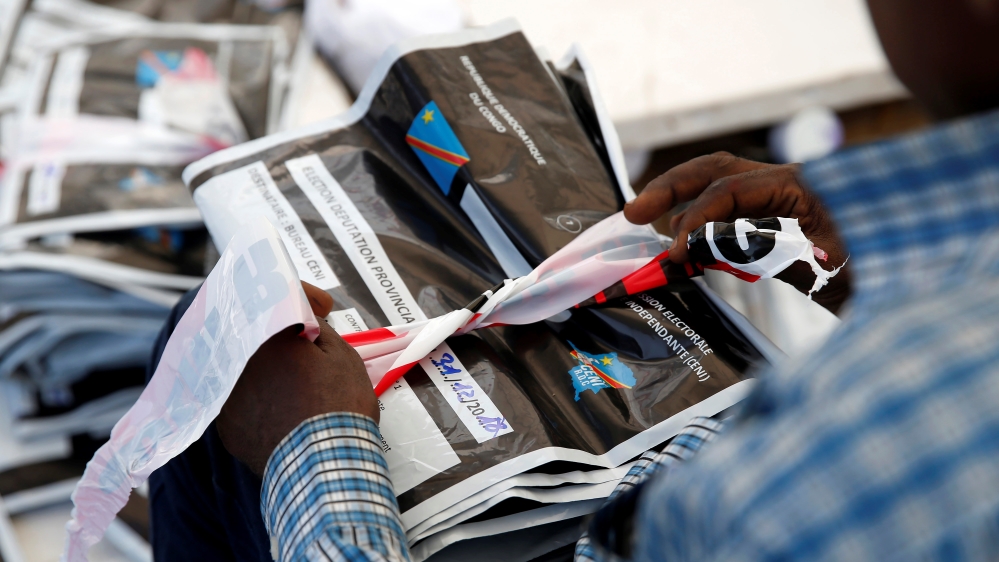 Man holds a bag containing voting materials at CENI tallying centre in Kinshasa