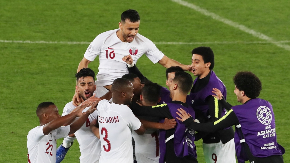 Qatar's Abdelaziz Hatim celebrates scoring their second goal with teammates [Ahmed Jadallah/Reuters]