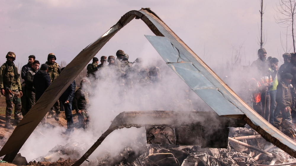 Indian soldiers stand next to the wreckage of Indian Air Force''s helicopter after it crashed in Budgam district in Kashmir February 27, 2019. REUTERS/Danish Ismail