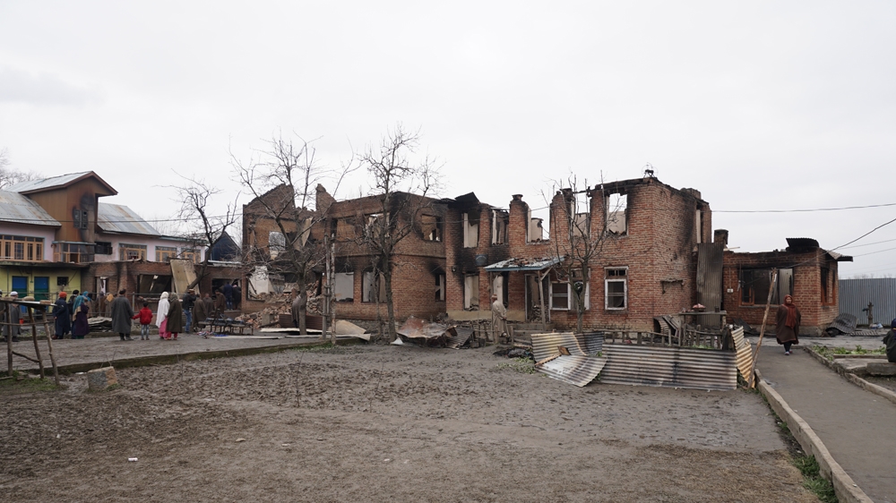 Houses damaged during a gun battle in south Kashmir's Pinglan village [Shabir Bhat/Al Jazeera]
