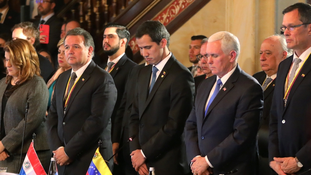 US Vice President Mike Pence and Venezuelan opposition leader Juan Guaido observe a minute of silence in honour of the victims of February 23 [Luisa Gonzalez/Reuters] 