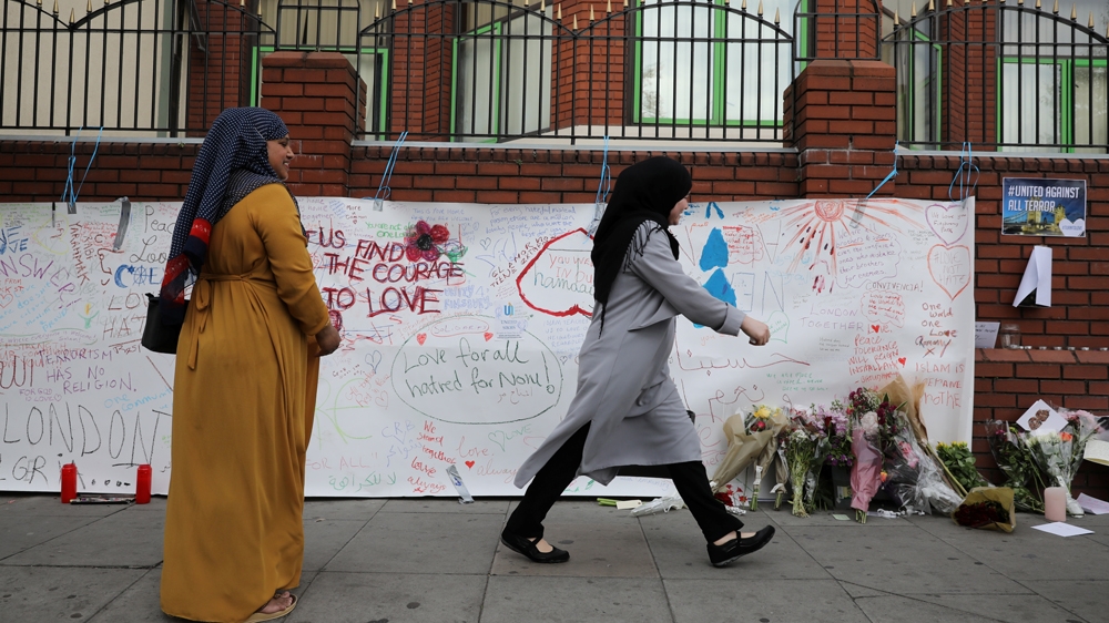 A woman walks past messages attached to a wall near the scene of an attack next to Finsbury Park Mosque, in north London Britain June 20, 2017. REUTERS/Marko Djurica