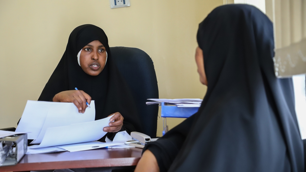 Ubah Hassan prepares to give 75,000 Birr ($2,645) in loans Hukum Aden Mohammed [Michael Tewelde/Al Jazeera]