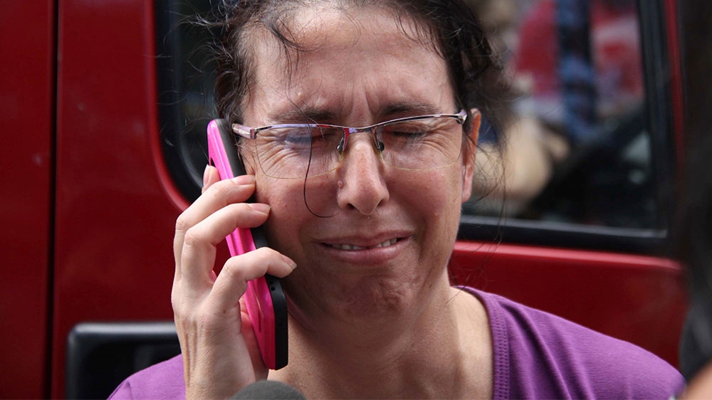 
Worried family members congregated outside the school after the shooting [Mauricio Sumiya/AP Photo]
