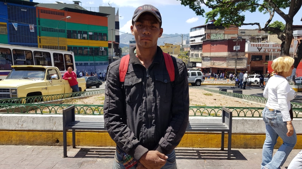 
William Alberto, 30: 'I'm here because the situation is just too [severe]. I'm not with the opposition, nor the government but we need to find a solution. If Hugo Chavez were here, he would not tolerate this [Elizabeth Melimopoulos/Al Jazeera]
