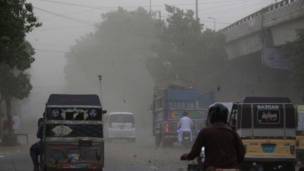 Vehicles commute during a dust storm in Karachi, Pakistan