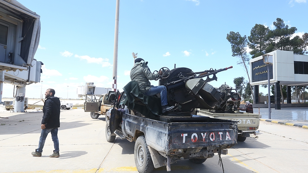 Fighting was under way on Monday at Tripoli's old airport [Mahmud Turkia/AFP]