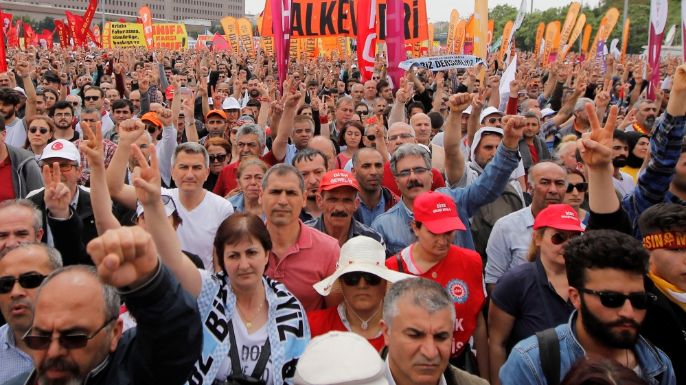 Demonstrators raise their fists during a May Day rally in Istanbul [Kemal Aslan/Reuters]