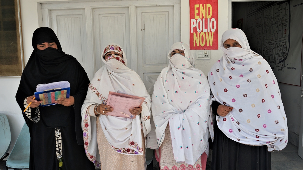 A group of polio campaign workers stand outside the YCP's Bara Banda centre in Nowshera, Pakistan [Sabrina Toppa/Al Jazeera]