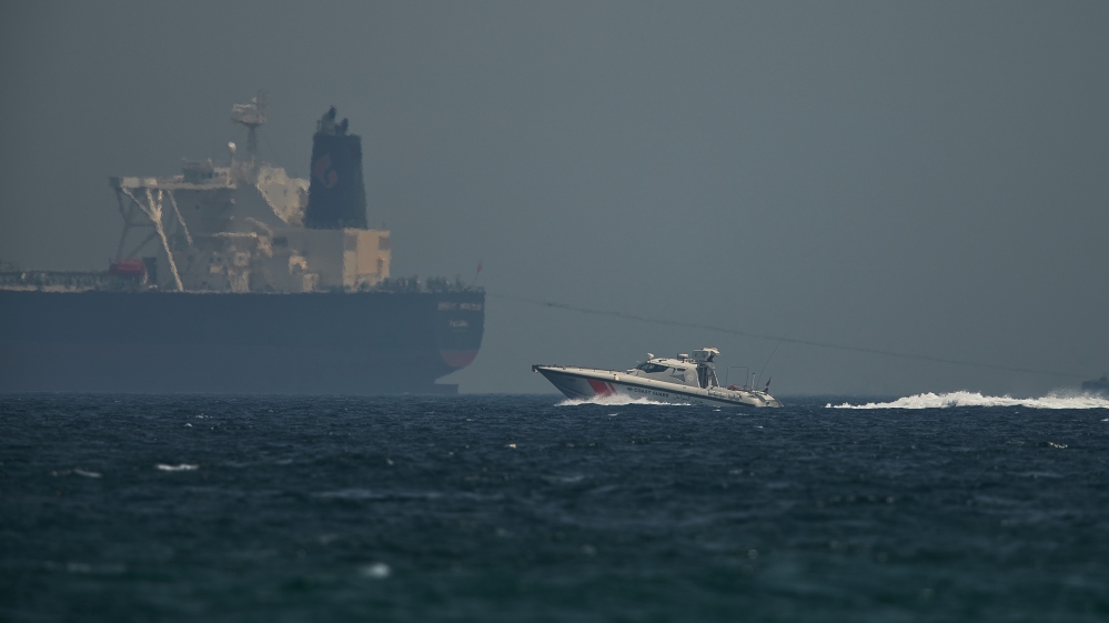 An Emirati coast guard vessel passes an oil tanker off the coast of Fujairah