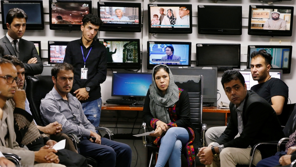 Afghan journalists attend a meeting in the Tolo newsroom, in Kabul, Afghanistan