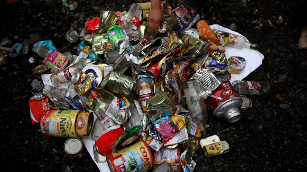 Workers from a recycling company display the garbage collected and brought from Mount Everest in Kathmandu
