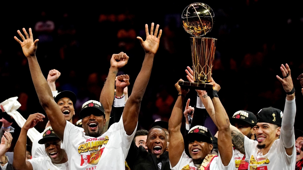 The Toronto Raptors celebrates with the Larry O"Brien Trophy after beating the Golden State Warriors in game six of the 2019 NBA Finals at Oracle Arena