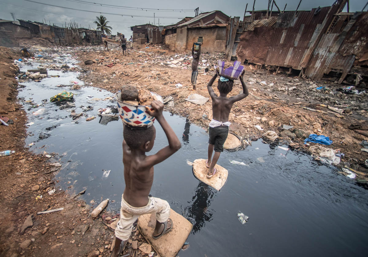 Kroo Bay is a slum in Sierra Leone’s capital Freetown. Roughly 7.000 people live on the densly populated 50 acres wide expanse with no electricity, running water or sewage system. Harsh living conditi