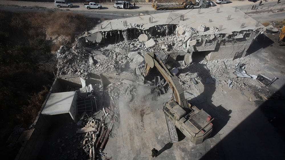 Israeli forces destroy a building in a Palestinian village of Sur Baher, east Jerusalem, Monday, July 22, 2019. Israeli work crews have begun demolishing dozens of Palestinian homes in an east Jerusal