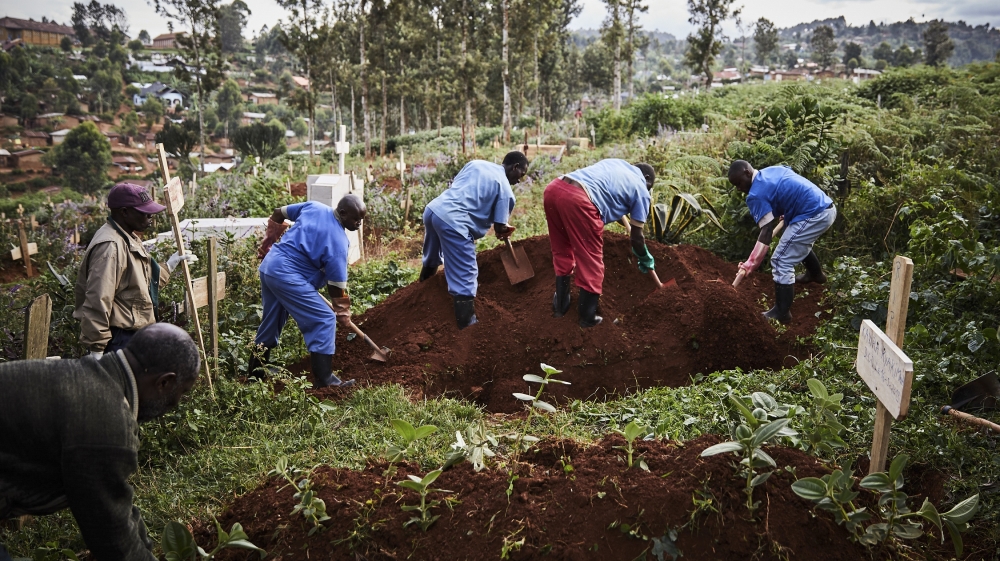 Health workers take part in the funeral of Ebola victims