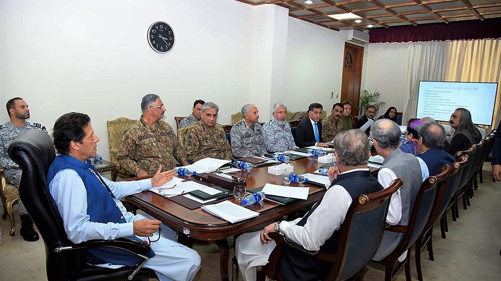 In this handout picture taken and released by Prime Minister Office (PMO) on August 7, 2019 Pakistan''s Prime Minister Imran Khan (L) chairs a National Security Committee meeting along with armed force