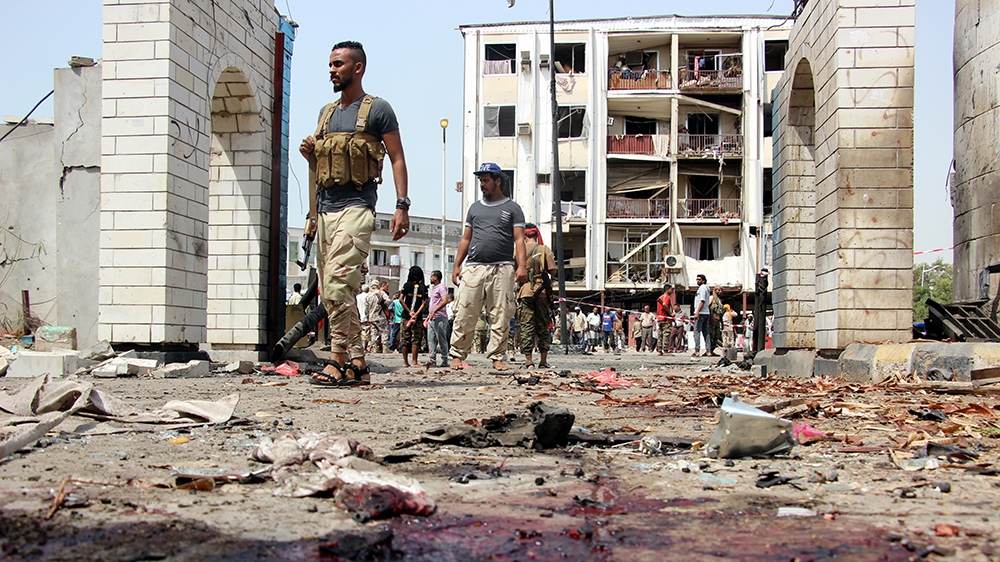 Yemeni soldiers inspect the site of a car bomb attack that targeted a police station in the southern port city of Aden, Yemen, 01 August 2019. According to reports, at least 40 security personnel and