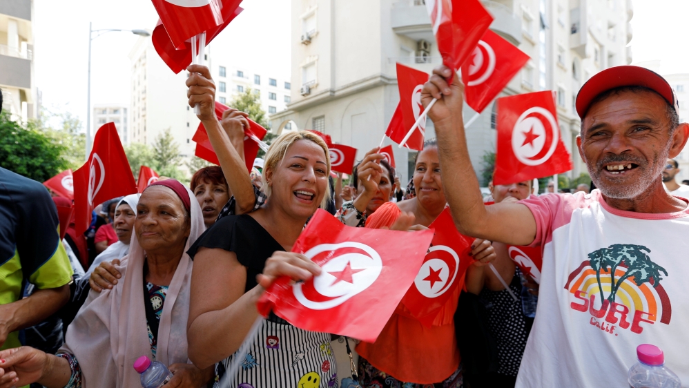 Supporters react after Tunisian Prime Minister Youssef Chahed submitted his candidacy for the presidential elections, in Tunis
