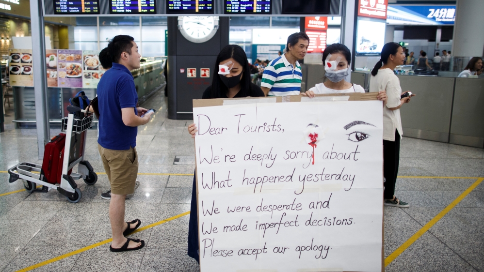Anti-government demonstrators apologize for yesterday''s clashes with police at the airport in Hong Kong