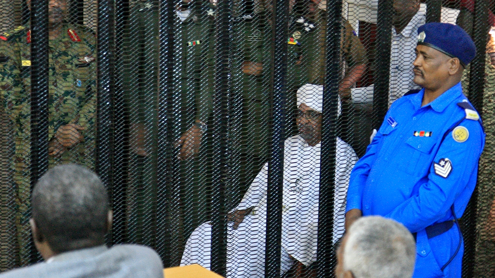Sudan''s deposed military ruler Omar al-Bashir sits in a defendant''s cage during the opening of his corruption trial in Khartoum on August 19, 2019. - Bashir has admitted to receiving $90 million in ca