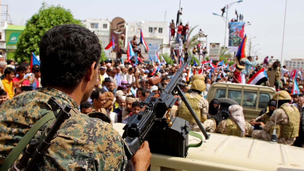 Members of UAE-backed southern Yemeni separatists forces are seen together with their supporters as they march during a rally in southern port city in Aden