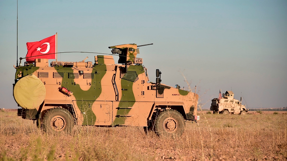 In this photo taken Thursday, Nov. 1, 2018, Turkish and U.S. troops conduct joint patrols around the Syrian town of Manbij, as part of an agreement that aimed to ease tensions between the two NATO all
