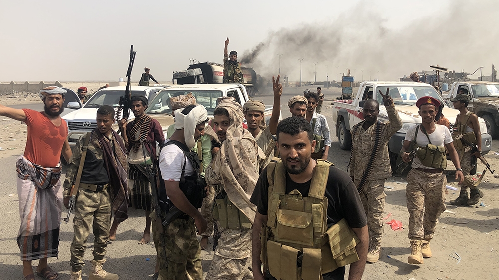 Fighters of the UAE-trained Security Belt Force, dominated by members of the Southern Transitional Council (STC) which seeks independence for south Yemen, flash the V-sign of victory at the al-Alam cr