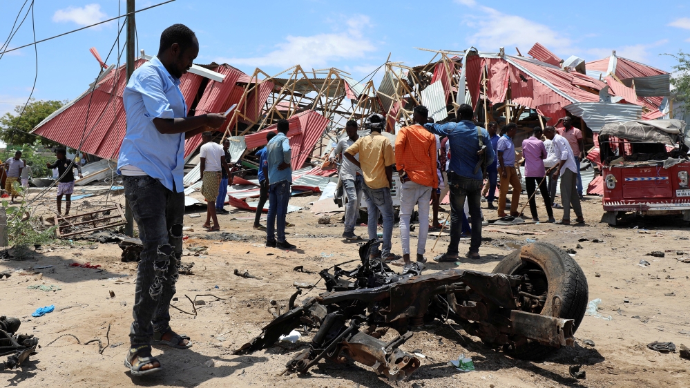 Somalis inspect the damage caused at the scene of an attack on an Italian military convoy in Mogadishu, Somalia September 30, 2019. REUTERS/Feisal Omar