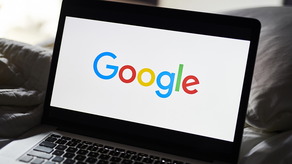 The Google Inc. logo is displayed on an Apple Inc. laptop computer in this arranged photograph taken in Little Falls, New Jersey, U.S., on Saturday, July 20, 2019