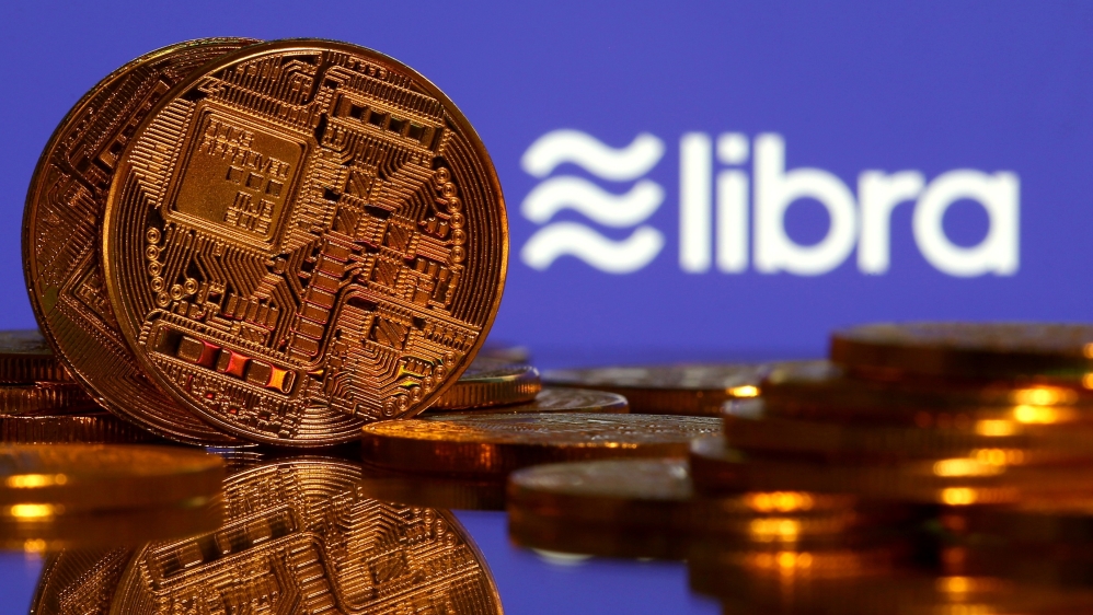 Representations of virtual currency are displayed in front of the Libra logo in this illustration picture, June 21, 2019