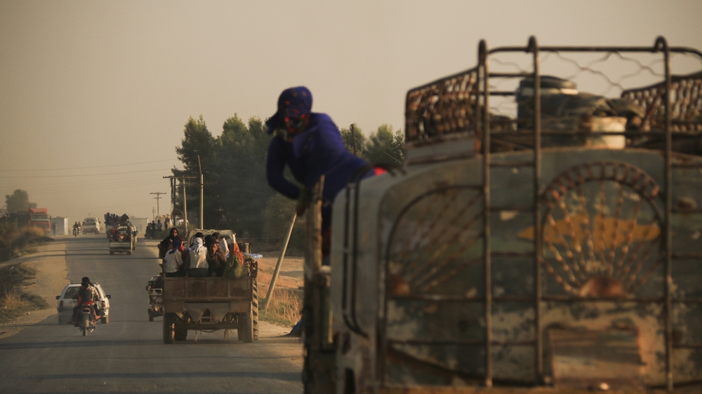 Syrians flee shelling by Turkish forces in Ras al Ayn, northeast Syria, Wednesday, Oct. 9, 2019.