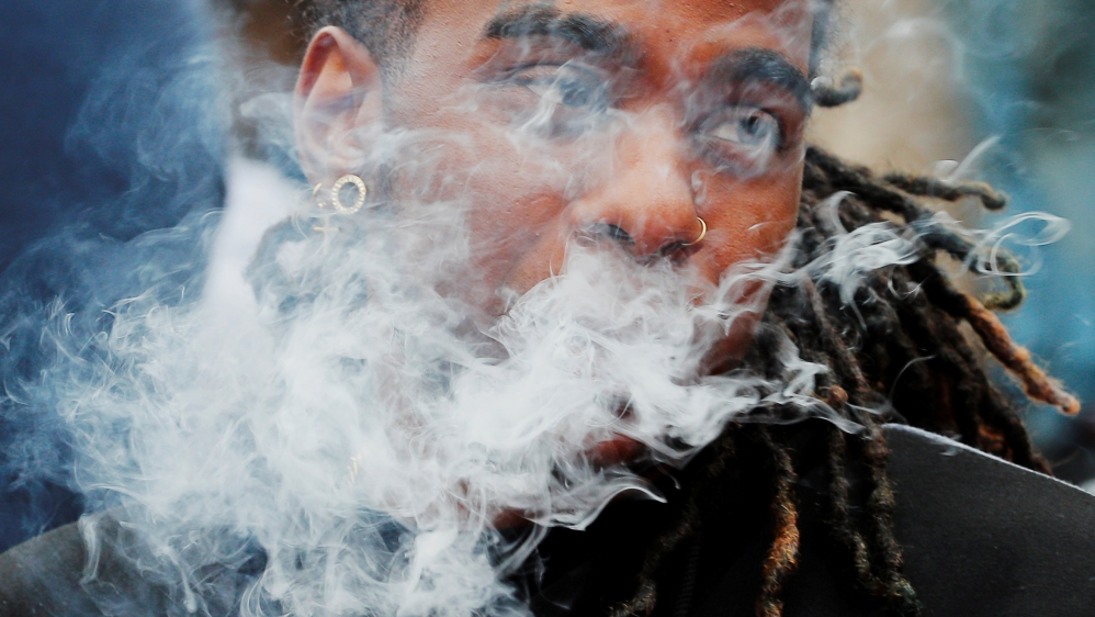 A demonstrator vapes during a protest in Boston