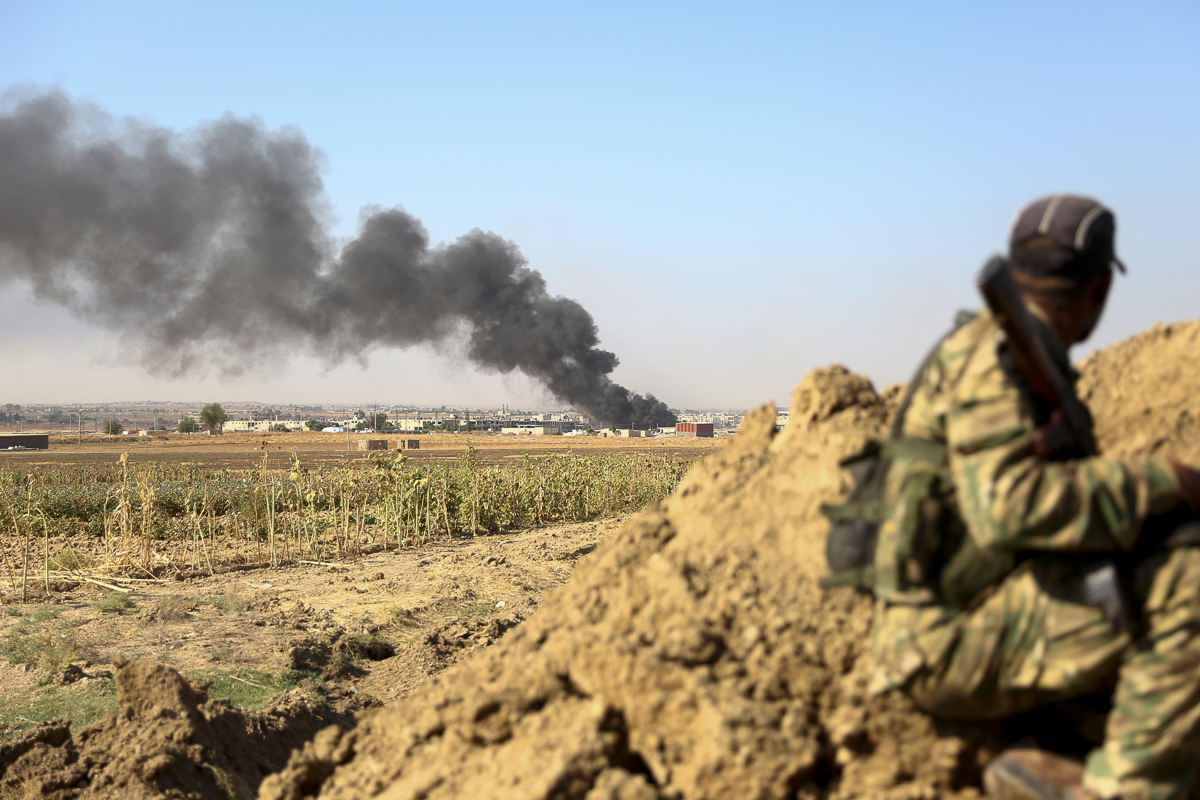 Turkish-backed Syrian rebels watch as smoke billows from the border town of Ras al-Ain on October 12, 2019, as Turkey and it''s allies continued their assault on Kurdish-held border towns in northeaste