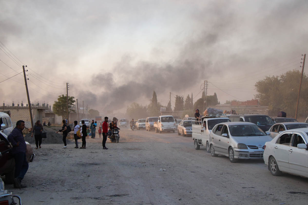 Syrians flee shelling by Turkish forces in Ras al Ayn, northeast Syria, Wednesday, Oct. 9, 2019. Turkish President Recep Tayyip Erdogan announced Wednesday the start of a Turkish military operation ag