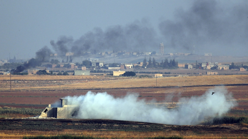 In this photo taken from the Turkish side of the border between Turkey and Syria, in Akcakale, Sanliurfa province, southeastern Turkey, smoke billows from targets inside Syria during bombardment